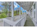Expansive balcony boasts classic white railings and peaceful views of the surrounding trees at 1294 Six Sisters St, Dacula, GA 30019