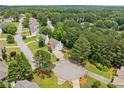 Aerial view of a residential neighborhood with mature trees and well-maintained homes at 1975 Fairway Close Ter, Lawrenceville, GA 30043