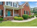 Charming front porch featuring a vibrant blue door and classic decor at 1975 Fairway Close Ter, Lawrenceville, GA 30043