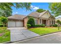 Elegant brick home boasts an attached two-car garage and a beautifully landscaped front yard at 2117 Stephens Walk, Dunwoody, GA 30338