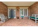Spacious brick front porch featuring comfortable seating and classic architectural details at 2117 Stephens Walk, Dunwoody, GA 30338