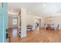 Bright, open-concept living room with hardwood floors and modern decor, seamlessly flowing into the dining area at 442 Mountain Park Trl, Stone Mountain, GA 30087