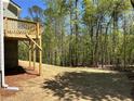 Wooden deck overlooks private backyard with lush trees at 66 Pine Creek Ct, Dallas, GA 30157