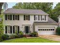 Charming two-story home with black shutters, a landscaped yard, and an attached two-car garage at 1981 Sumter Ct, Lawrenceville, GA 30044