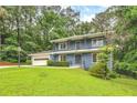 Charming two-story blue home featuring a spacious front yard and a two-car garage at 2210 Chrysler Ne Ter, Atlanta, GA 30345