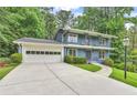 Two-story home with well-maintained lawn, manicured hedges, concrete drive and front-facing balcony at 2210 Chrysler Ne Ter, Atlanta, GA 30345