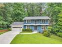 Charming two-story blue home featuring a spacious front yard and a two-car garage at 2210 Chrysler Ne Ter, Atlanta, GA 30345
