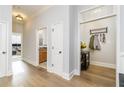 Bright hallway with hardwood floors, neutral walls, and convenient access to office, bathroom, and coat closet at 11 Perimeter E Ctr # 1412, Atlanta, GA 30346