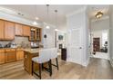 Open kitchen with wooden cabinets, granite countertops, stainless appliances, island seating, and seamless flow to living areas at 11 Perimeter E Ctr # 1412, Atlanta, GA 30346