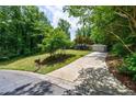Landscaped front yard with a long driveway to a single story home at 135 Pheasant Se Dr, Marietta, GA 30067