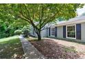 Inviting exterior with mature trees and dark shutters on a single-story home at 135 Pheasant Se Dr, Marietta, GA 30067