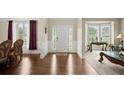 Elegant foyer featuring hardwood floors, paneled walls, and an inviting front door at 1709 Grove Se Ct, Conyers, GA 30013