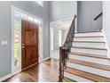 Grand foyer featuring hardwood floors, a staircase with iron railings, and soaring ceilings at 1870 Milfield Cir, Snellville, GA 30078