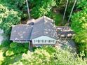 Aerial view of a home with a brown roof surrounded by lush greenery at 7310 Ne Wynhill Ne Dr, Atlanta, GA 30328