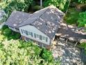An aerial view of a house with an attached carport, enveloped by dense trees at 7310 Ne Wynhill Ne Dr, Atlanta, GA 30328