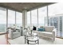 Bright living room featuring floor-to-ceiling windows and contemporary decor at 855 Peachtree Ne St # 2913, Atlanta, GA 30308
