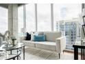 Modern living room showcasing a comfortable sofa and an expansive window view at 855 Peachtree Ne St # 2913, Atlanta, GA 30308