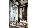 Bright living room featuring high ceilings, floor-to-ceiling windows, and modern starburst lighting at 855 Peachtree Ne St # 2913, Atlanta, GA 30308