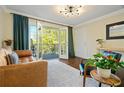 Cozy living room with stylish furniture and access to a balcony through glass doors at 869 Briarcliff Ne Rd # B20, Atlanta, GA 30306