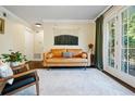 Relaxing living room with neutral walls, hardwood floors, and glass doors to an outdoor balcony at 869 Briarcliff Ne Rd # B20, Atlanta, GA 30306