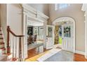 Bright foyer with hardwood floors, grand staircase, and view into formal dining room at 443 Langley Oaks Dr, Marietta, GA 30067