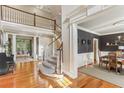 Elegant foyer featuring a curved staircase, hardwood floors, and open view of dining room at 443 Langley Oaks Dr, Marietta, GA 30067