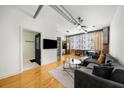 Open concept living room featuring hardwood floors, modern lighting, and an exposed ceiling at 800 Peachtree Ne St # 8607, Atlanta, GA 30308