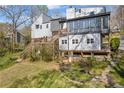 Beautiful backyard view showing multi-tiered decks, full sunroom, steps, and landscaping at 10845 Shallowford Rd, Roswell, GA 30075