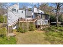 A well-maintained backyard view showing multi-tiered decks, steps, landscaping, and lots of privacy at 10845 Shallowford Rd, Roswell, GA 30075