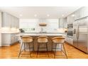 Modern kitchen with an island, stylish seating, stainless steel appliances, and custom cabinets at 1329 W Nancy Creek Ne Dr, Brookhaven, GA 30319
