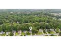 Aerial view showcasing a home nestled among mature trees in a quiet residential neighborhood at 5519 Princeton Oaks Ln, Sugar Hill, GA 30518