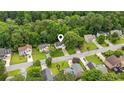 An aerial view reveals a home surrounded by tall trees in a residential neighborhood at 5519 Princeton Oaks Ln, Sugar Hill, GA 30518