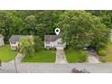 Aerial view of a well-maintained home with a green lawn and mature trees in a residential neighborhood at 5519 Princeton Oaks Ln, Sugar Hill, GA 30518