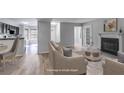 Open living space featuring a fireplace, kitchen view, and natural light at 2135 N Forest Trl, Dunwoody, GA 30338