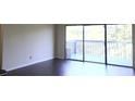 Spacious living room with modern flooring and sliding glass doors to a balcony with wooded views at 3575 Oakvale Rd # 919, Atlanta, GA 30034