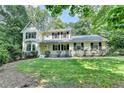 Charming two-story home with a well-manicured lawn and mature trees offering curb appeal at 10035 Anaheim Dr, Alpharetta, GA 30022