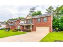 Beautiful two-story brick home with well-manicured lawn, black shutters and a spacious driveway leading to a two-car garage at 12275 Styron Dr, Hampton, GA 30228