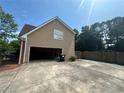 Detached garage with siding, a concrete driveway, and a partially open door at 2295 Amberbrook Lane Ln, Grayson, GA 30017