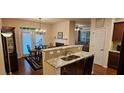 Open floorplan kitchen and dining area with French doors to backyard at 3150 Woodwalk Se Dr # 3112, Atlanta, GA 30339