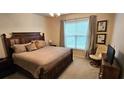 Spacious bedroom features a decorative ceiling fan, a king-size bed, and a window at 3150 Woodwalk Se Dr # 3112, Atlanta, GA 30339