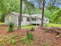 View of the side of the house showcasing the yard and the front porch at 4060 Highway 81, Hampton, GA 30228