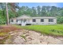 View of the front of the house showcasing the yard and the front porch at 4060 Highway 81, Hampton, GA 30228