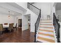 Bright foyer with staircase, hardwood floors, and adjacent dining room at 505 Stedford Lane, Duluth, GA 30097