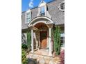Close-up of the front door with stone accents and an arched portico at 5140 Long Island Nw Dr, Sandy Springs, GA 30327