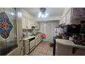 Functional kitchen with classic cabinets, tile flooring and stainless appliances at 932 Chippendale Ln, Norcross, GA 30093
