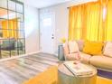 Living room featuring stylish couch and decor, hardwood floors, and modern mirror at 2190 Gordon Se Cir, Smyrna, GA 30080