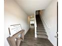 Bright foyer with hardwood floors, leading to carpeted stairs and showcasing an inviting space with modern decor at 3341 Sable Elm Ct, Atlanta, GA 30349
