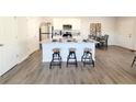 Stylish kitchen featuring white cabinets, stainless steel appliances, granite countertops, and a sociable center island at 3341 Sable Elm Ct, Atlanta, GA 30349
