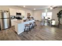 Open concept kitchen with an island, modern appliances, and bar stool seating, creating an inviting space at 3341 Sable Elm Ct, Atlanta, GA 30349