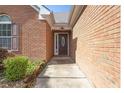 Close-up of the entryway featuring a lovely front door and brick siding at 3946 Village Crossing Ln, Ellenwood, GA 30294